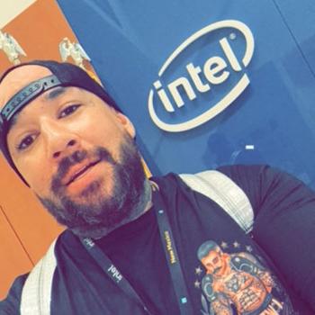 Kevin Chavez in front of the Intel signage